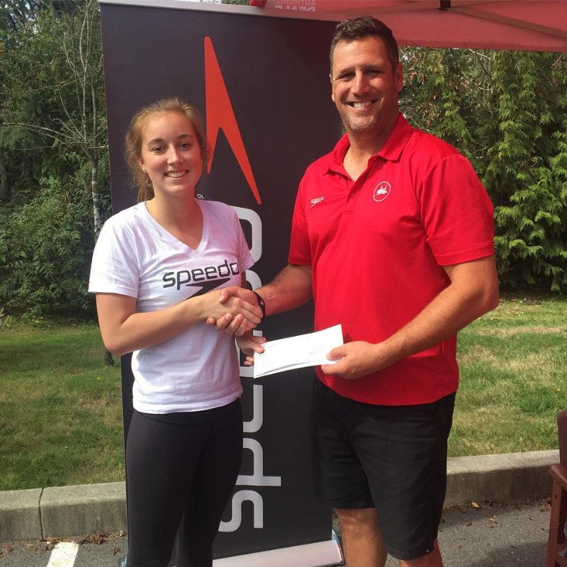 Emily Overholt shaking hands with Team Aquatic Supplies General Manager Greg Sanderson