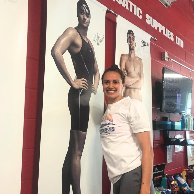 Kylie Masse signing her poster at Team Aquatic Supplies TPASC